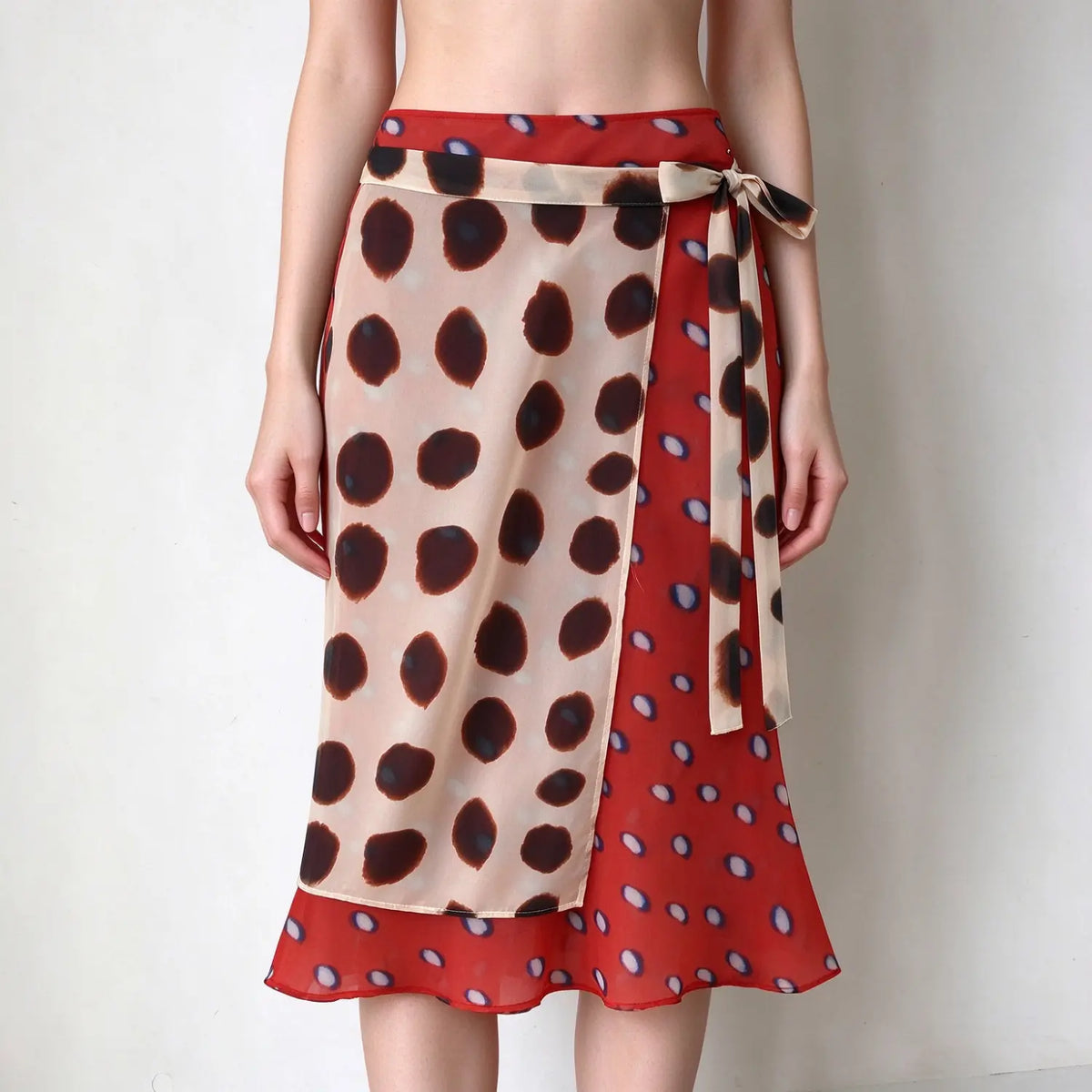 Model wearing red and beige spotted wrap midi skirt, two-tone polka dot print, side tie waist, sheer chiffon fabric, ruffle hem