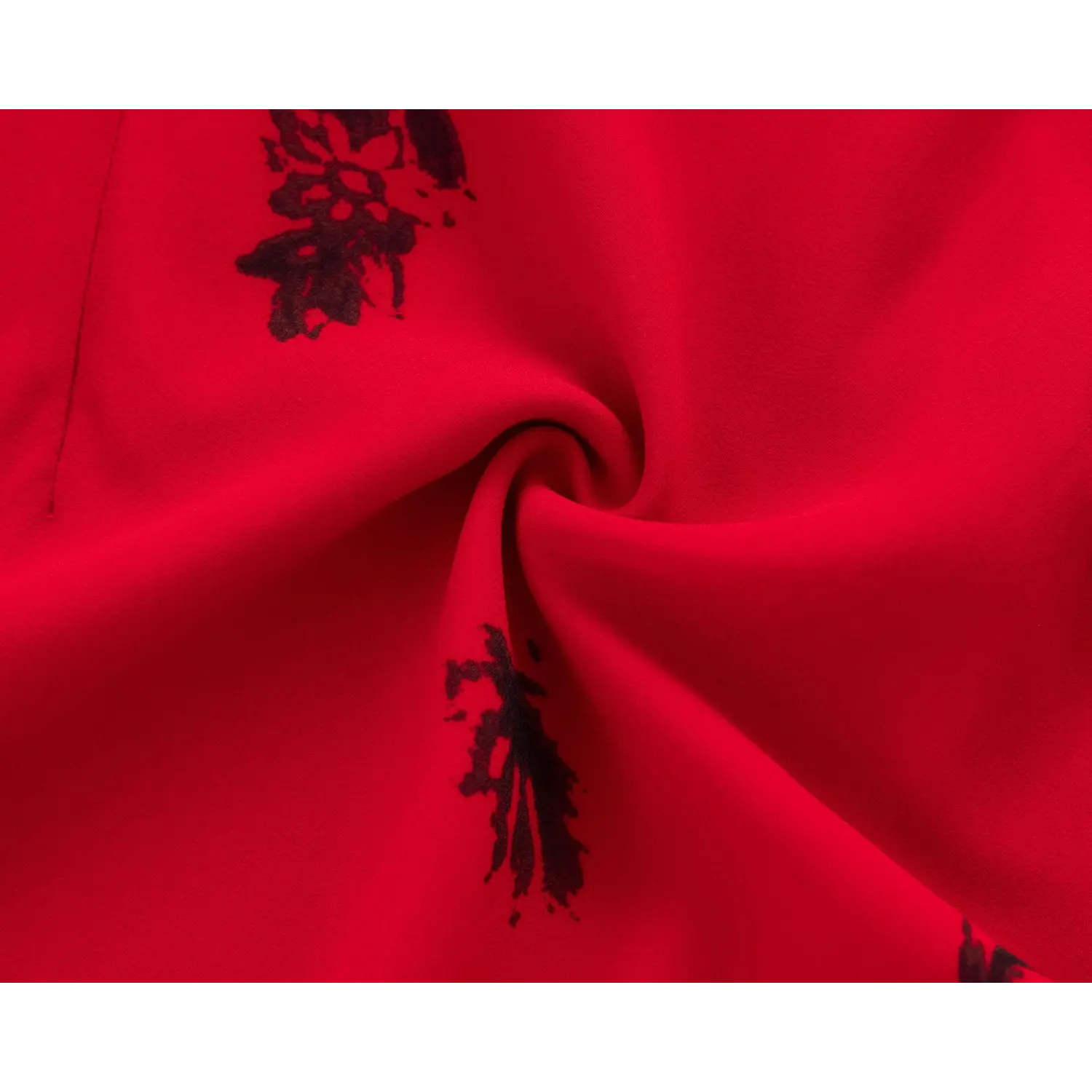 Twisted fabric close‑up, soft lightweight red chiffon material with vintage black floral print texture