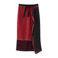 Studio white background full front shot of red black reversible wrap midi skirt, elastic waistband with self tie ribbon, two-sided geometric dot print, contrast piping trim, asymmetrical wrap hem