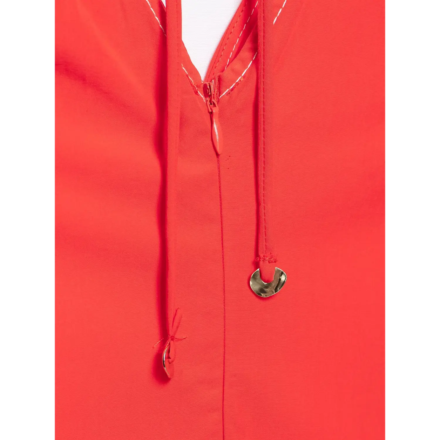 Close up of self tie string with metal charm on red open back top