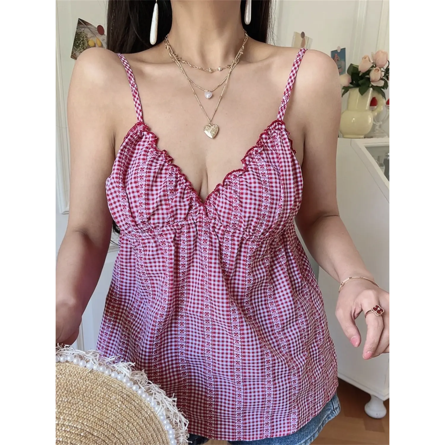 Red white gingham floral scalloped cami top half body vibe shot, loose babydoll v-neck gathered bust, model with pearl frayed straw hat soft casual indoor styling