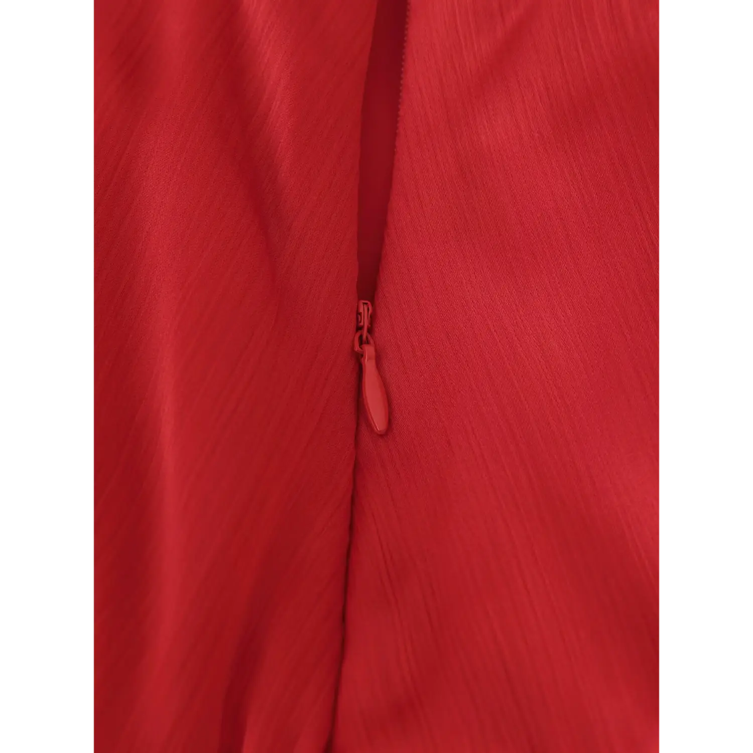 Close up of invisible matching red zipper on textured red chiffon maxi skirt fabric