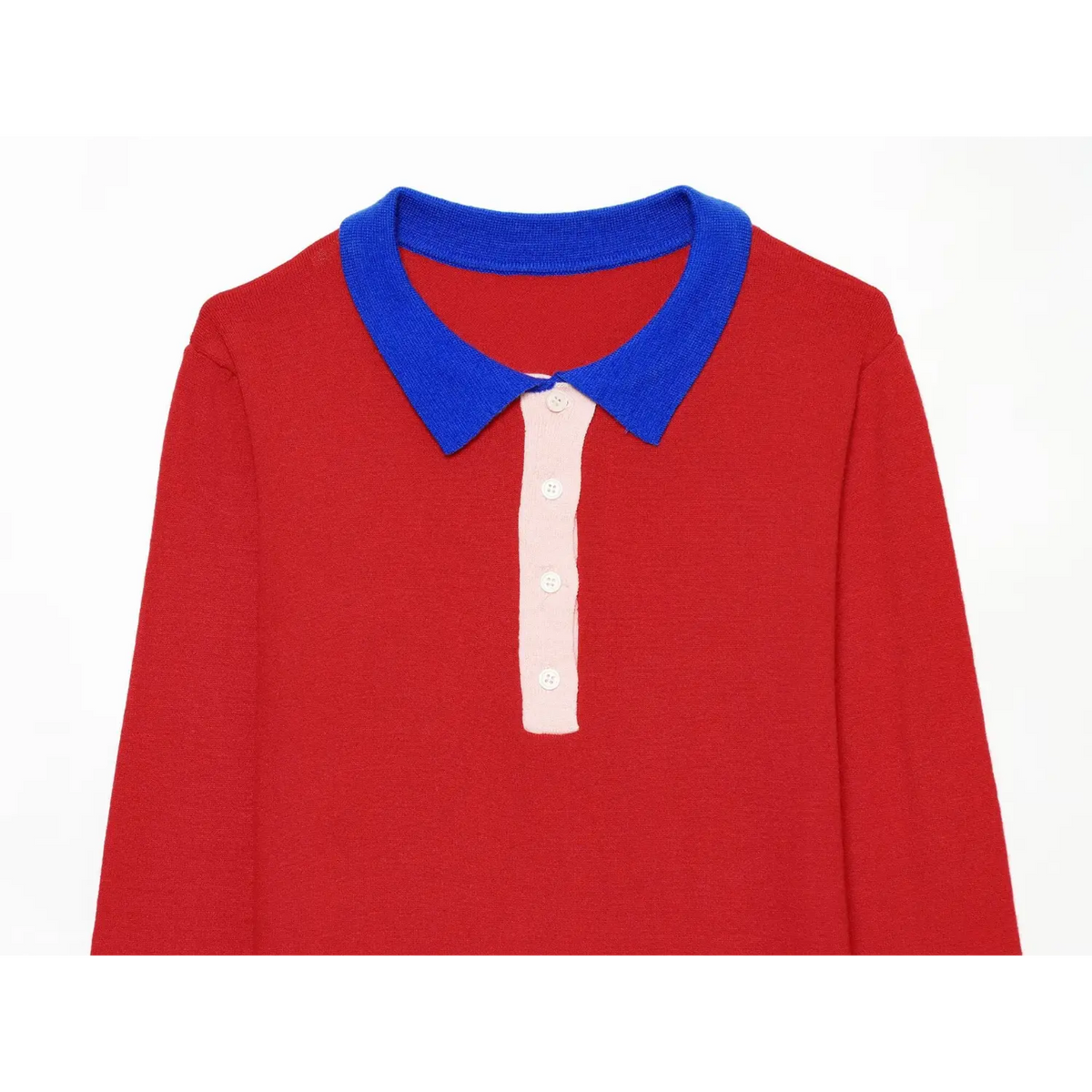 Close-up of front chest on red color block knit polo top, blue collar and pink button placket