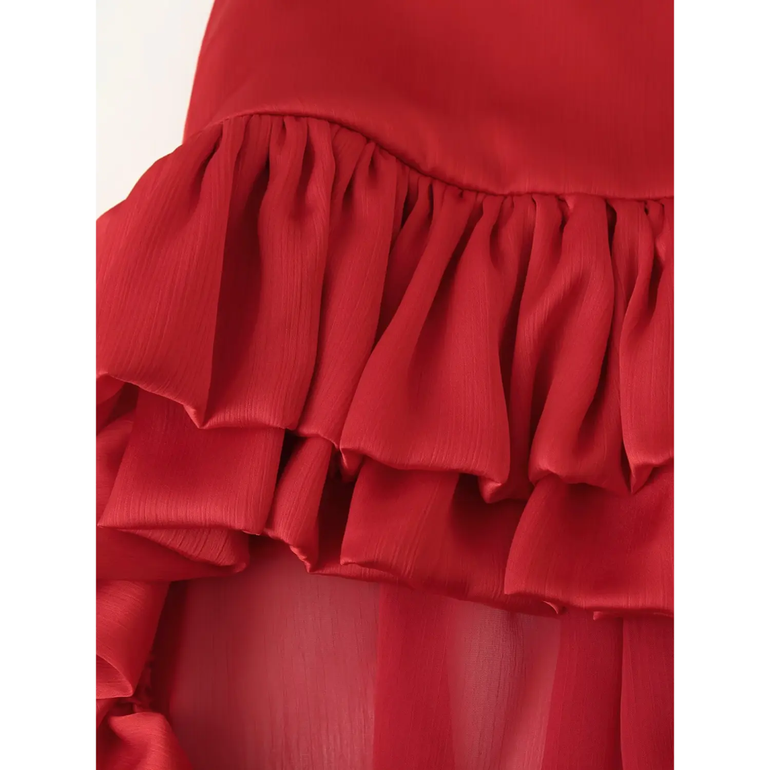 Detailed close up of double stacked satin frill texture on red chiffon long skirt