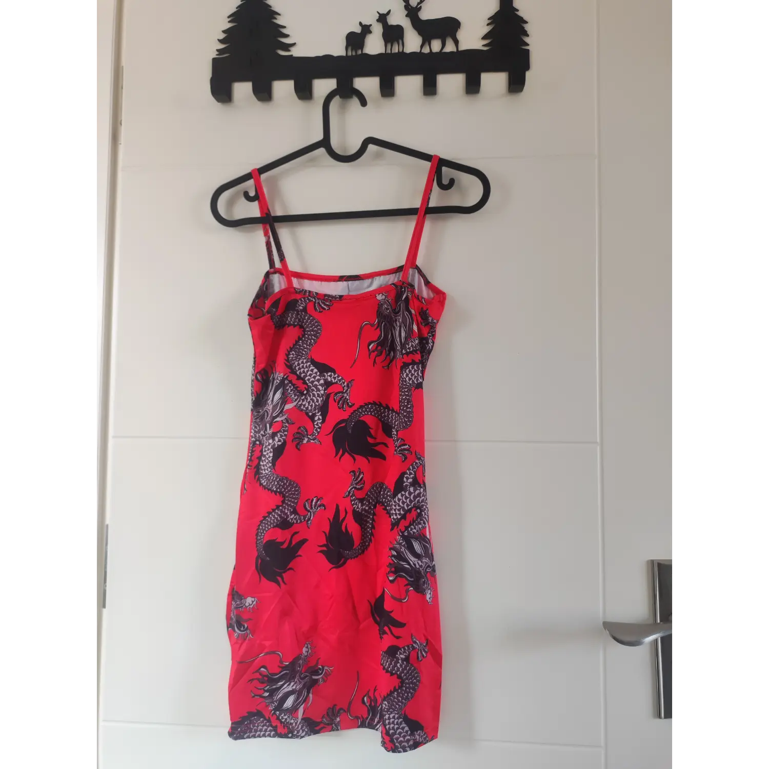 Back hanging view, red dragon pattern spaghetti strap mini bodycon dress hanging on door hook