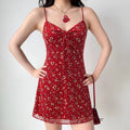 Red floral sparkle cami mini dress model natural light half body wearing shot, V-neck drawstring shape bust waist-cinched lengthen proportion vintage red floral date outfit display