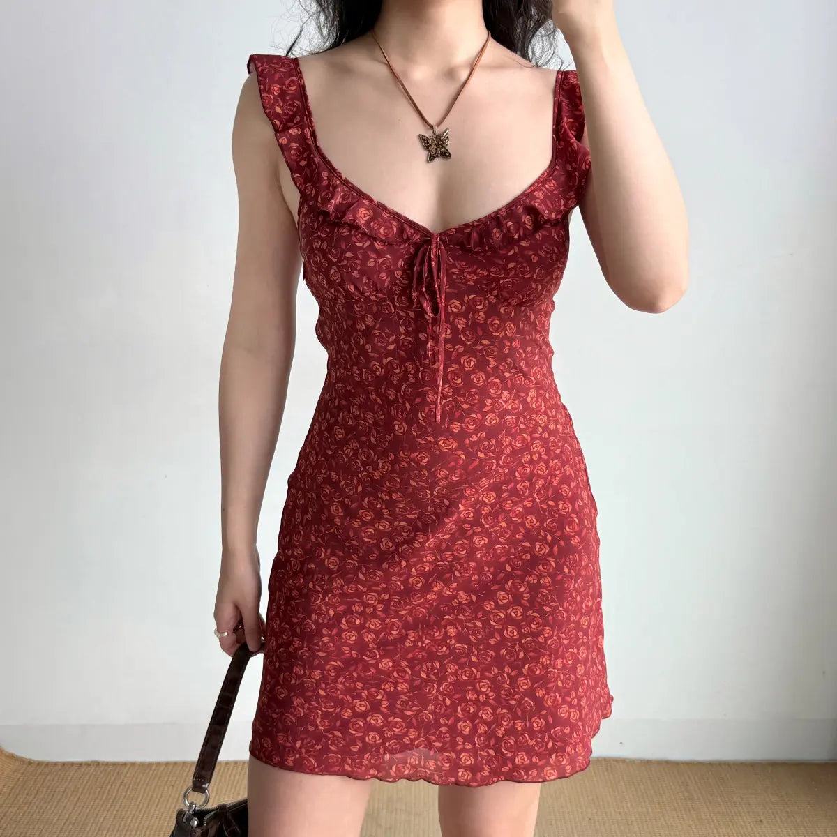 The full outfit of the red rose print mini dress, styled with accessories.