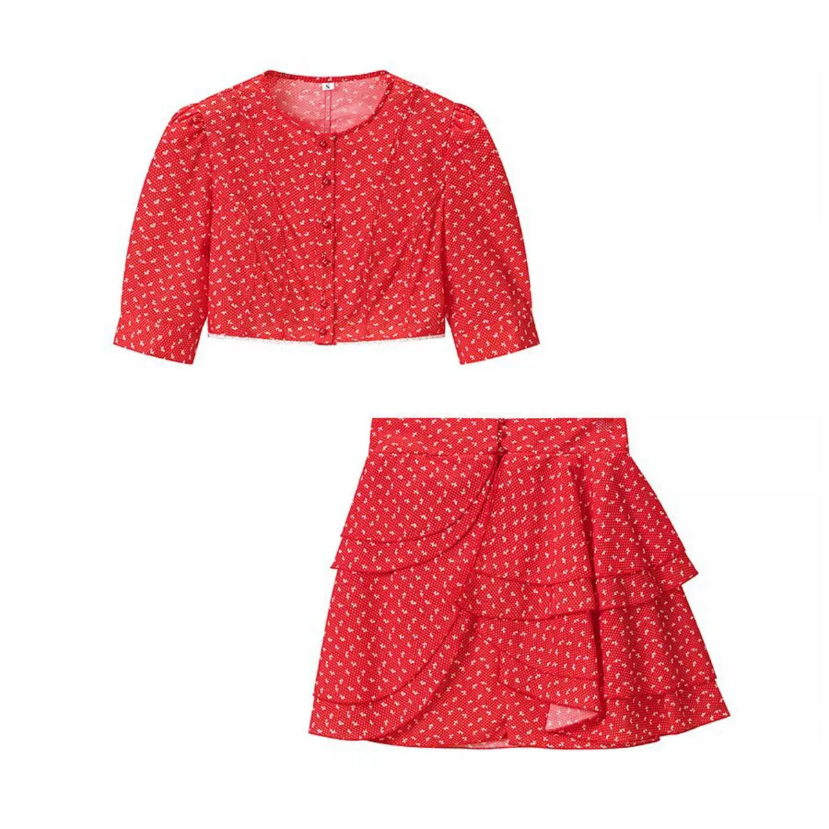 Flat lay of red ditsy floral two‑piece outfit, cropped puff sleeve top and ruffle tiered mini skirt