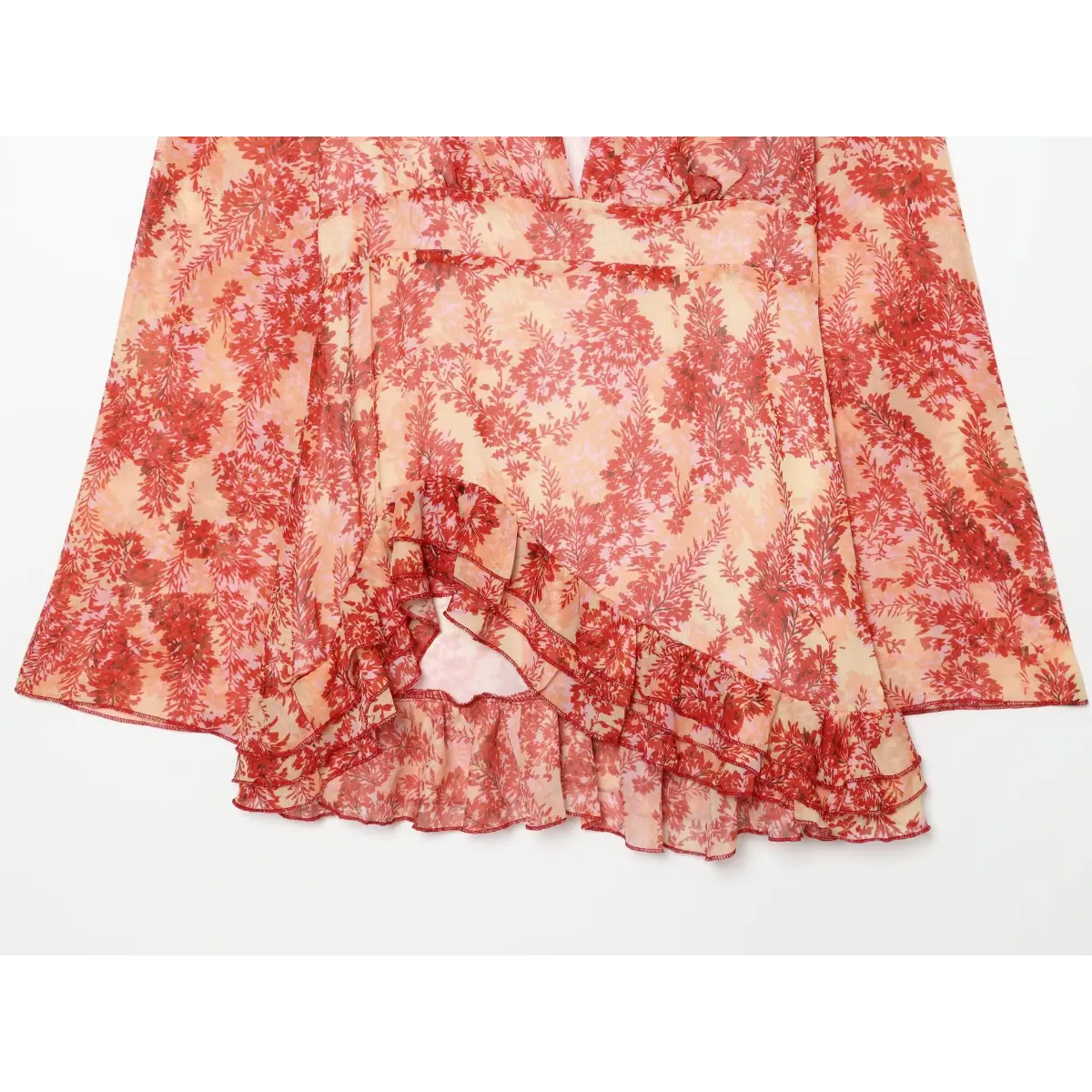 Close-up of the ruffled hem and back silhouette on the red floral wrap dress