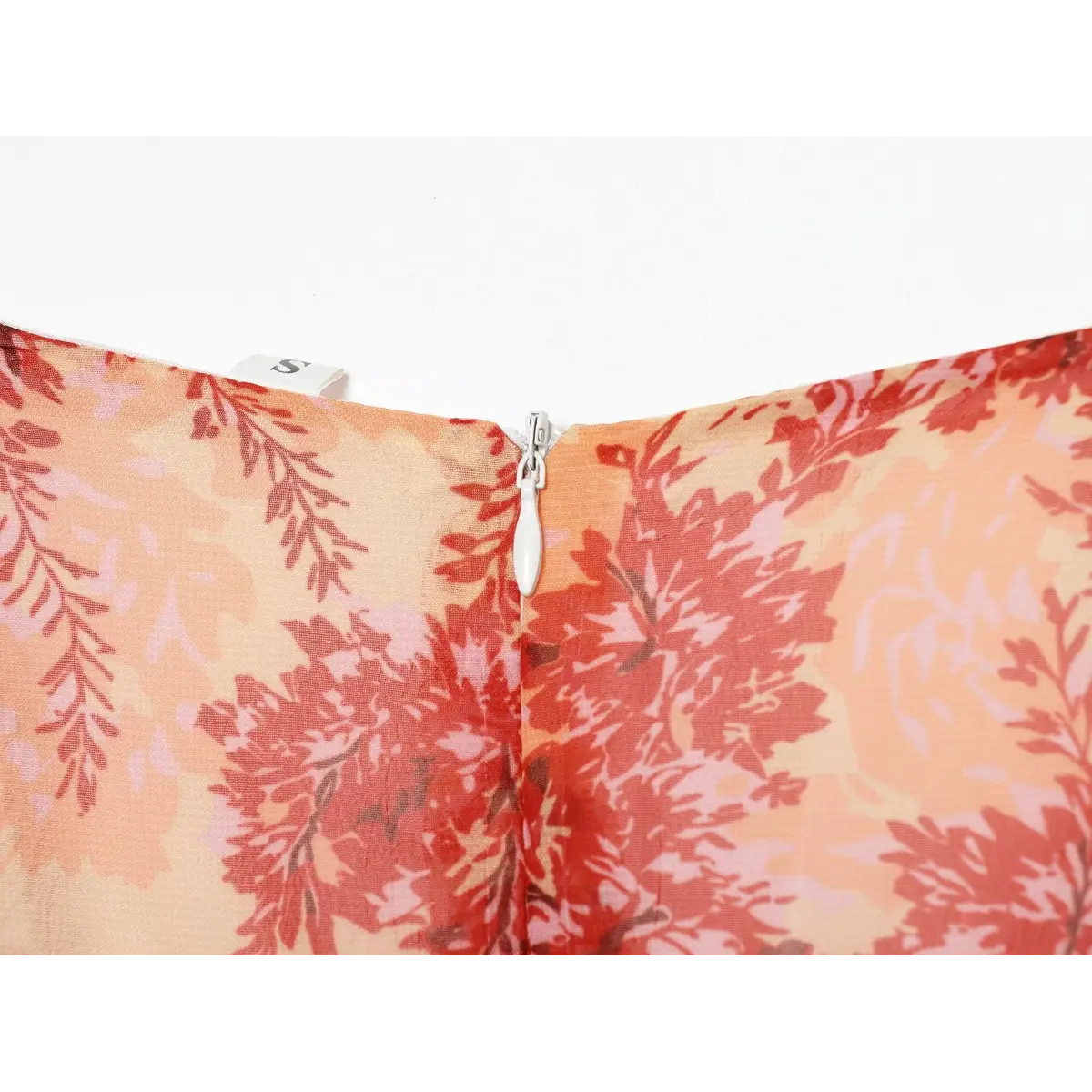 Close-up of the side zipper detail on the red floral wrap dress