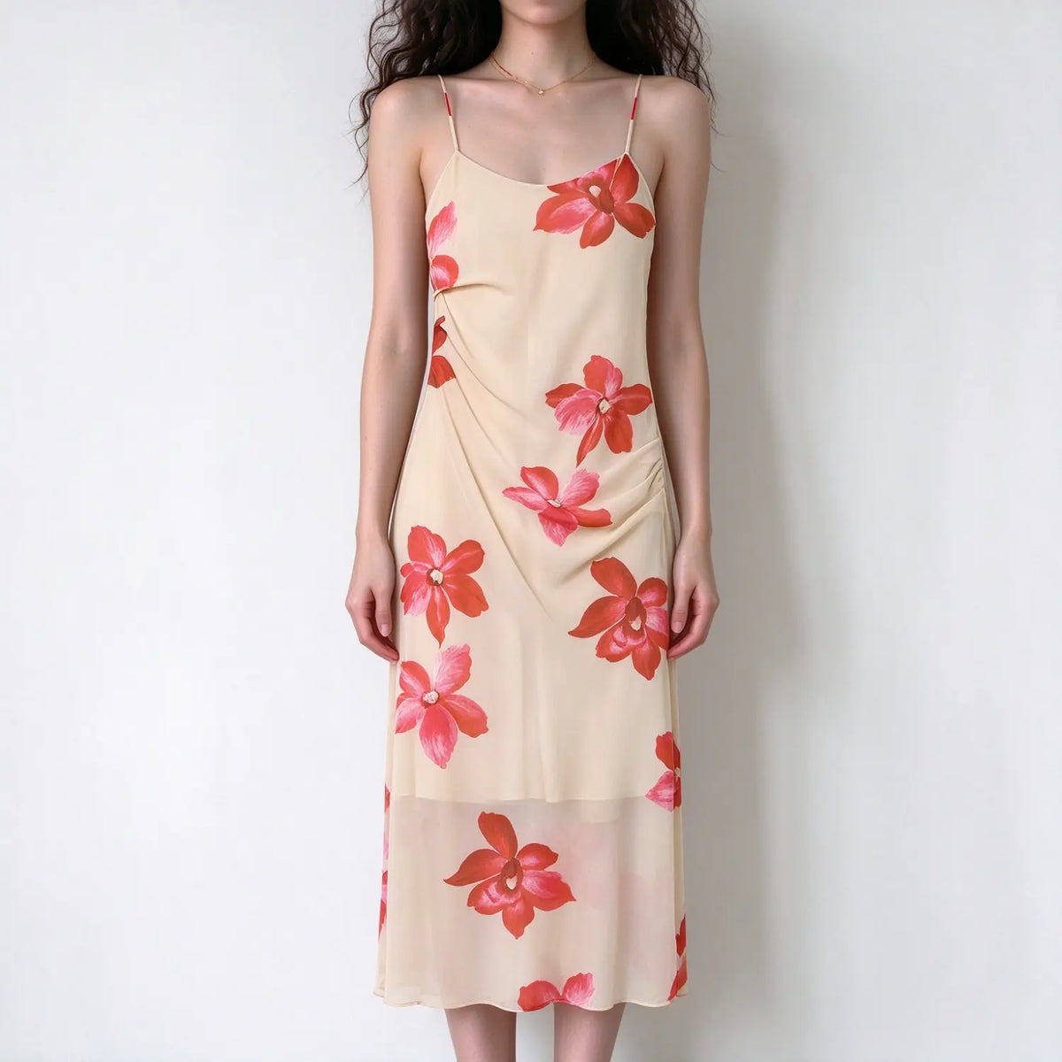 Female model front view wearing cream base red floral cami maxi dress, spaghetti strap, side ruched detail, sheer flowy long skirt