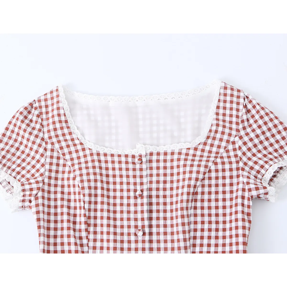 Close-up of the square neckline, lace trim, and gingham fabric on the red dress