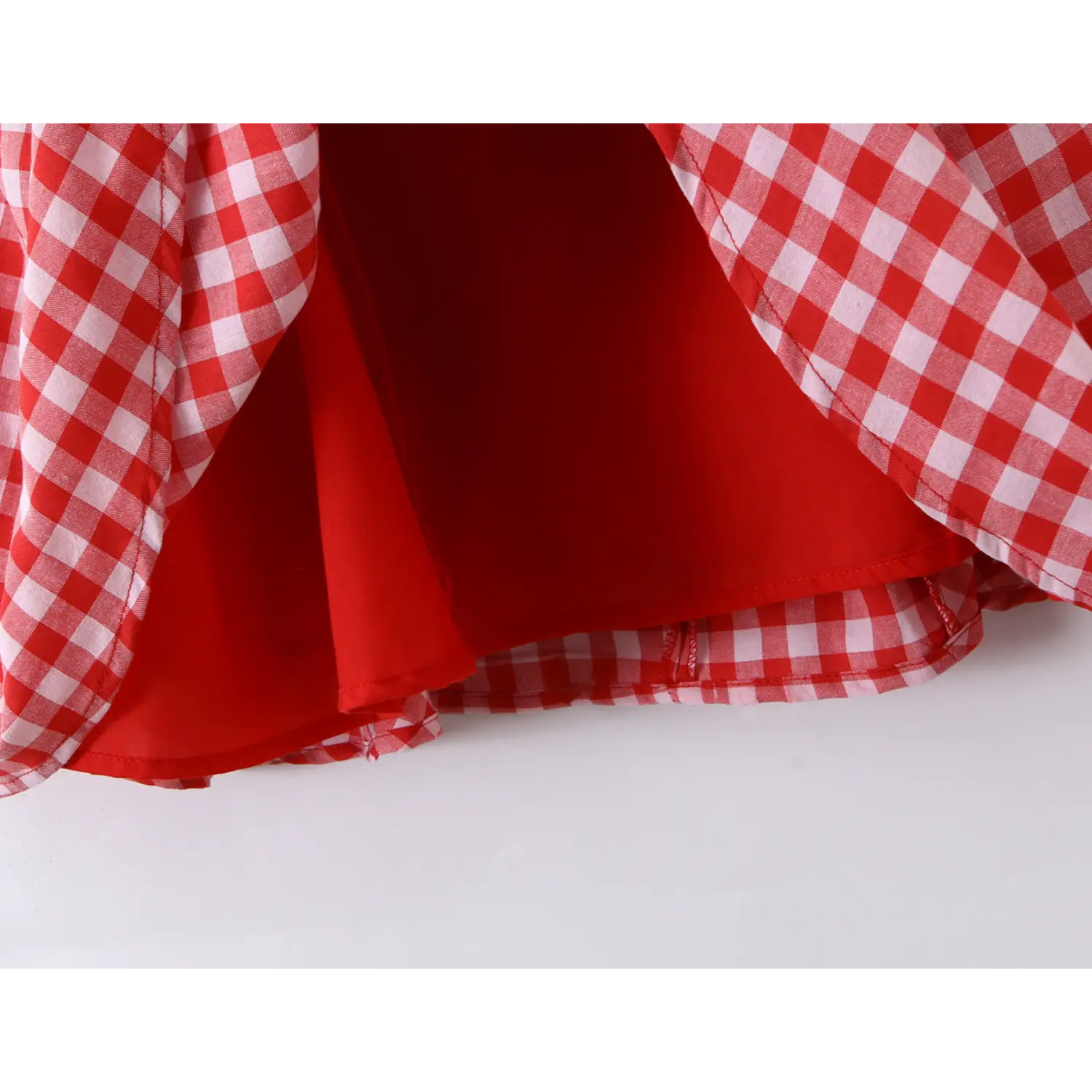 Close‑up red inner lining and seam construction red gingham mini dress