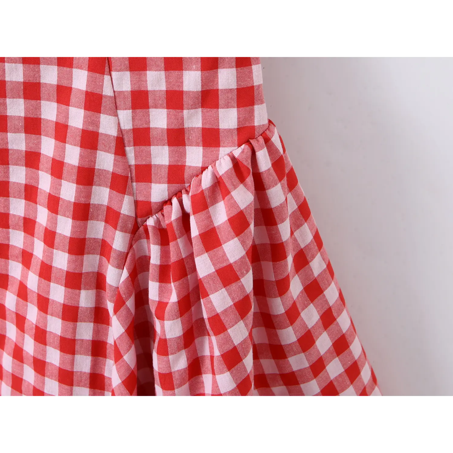 Close‑up skirt ruffle gathering seam red gingham sleeveless mini dress