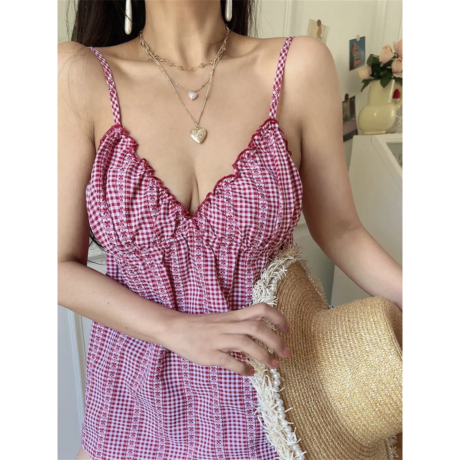 Red white gingham floral scalloped cami top half body vibe shot, v-neck gathered loose babydoll fit, layered heart gold necklaces soft girly indoor styling