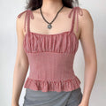 The gingham top styled on a model, highlighting its vintage-inspired design and how it pairs with casual bottoms.