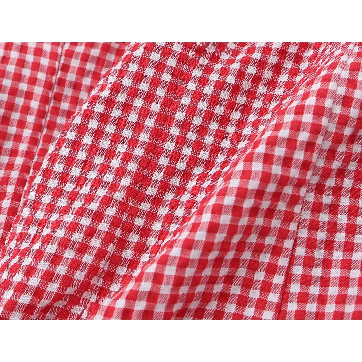 Close-up of the fabric, showing the gingham weave and the slight crinkle texture.