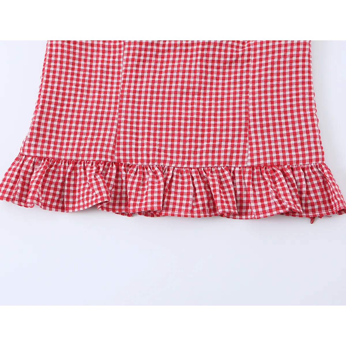 Close-up of the bottom edge, showing the ruffled peplum hem.