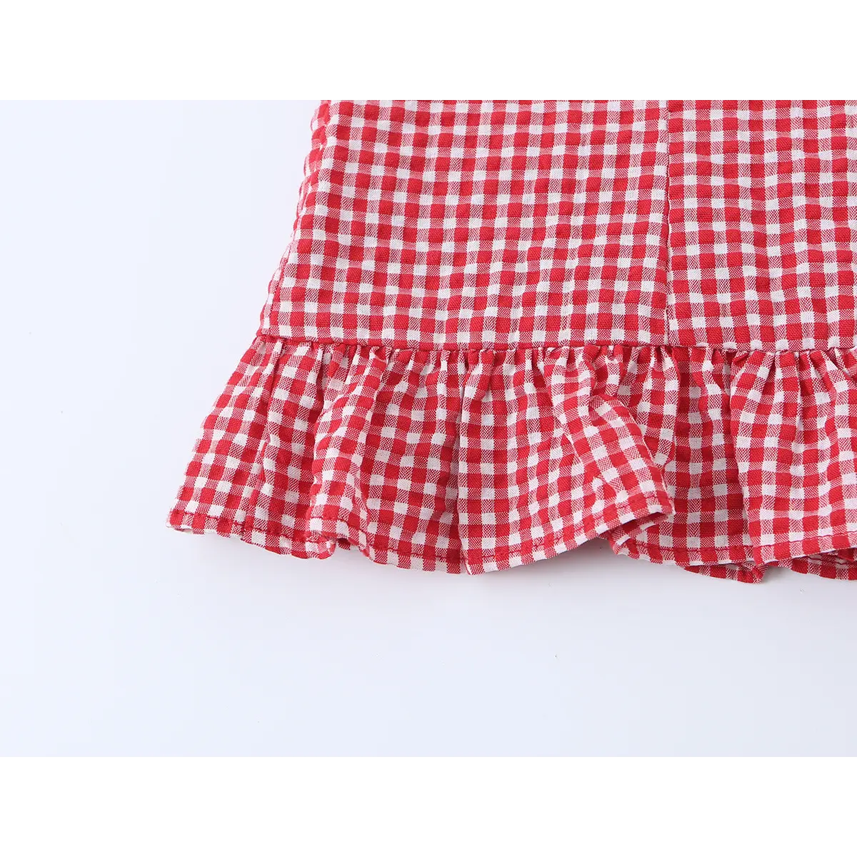 Close-up of the bottom edge, showing the ruffled peplum hem.