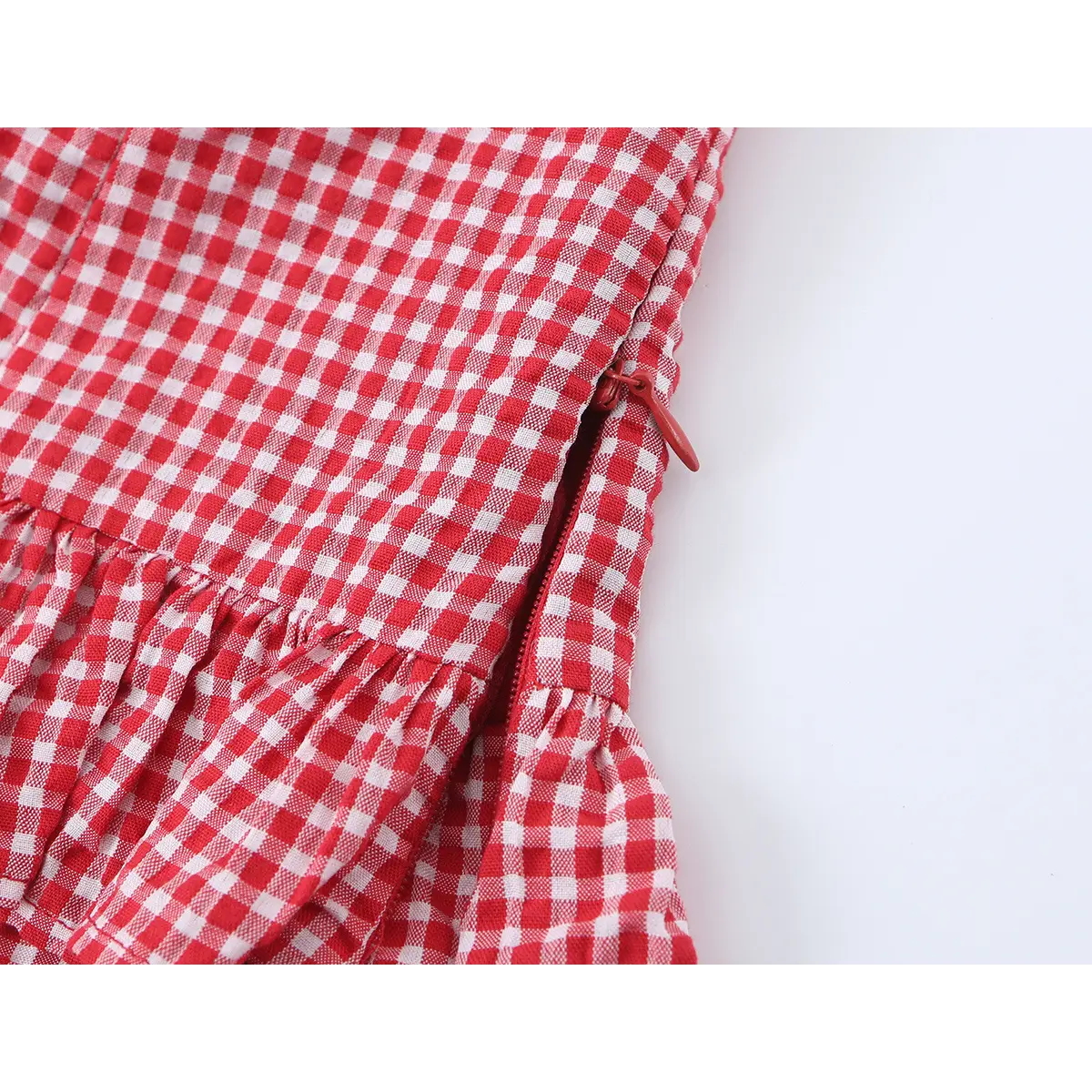 Close-up of the side seam, showing the hidden zipper with a red pull tab for easy closure.