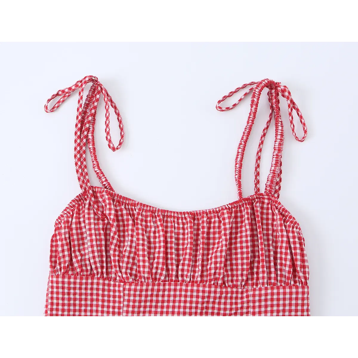 Close-up of the shoulder straps, showing the smocked elastic and the self-tie closure.