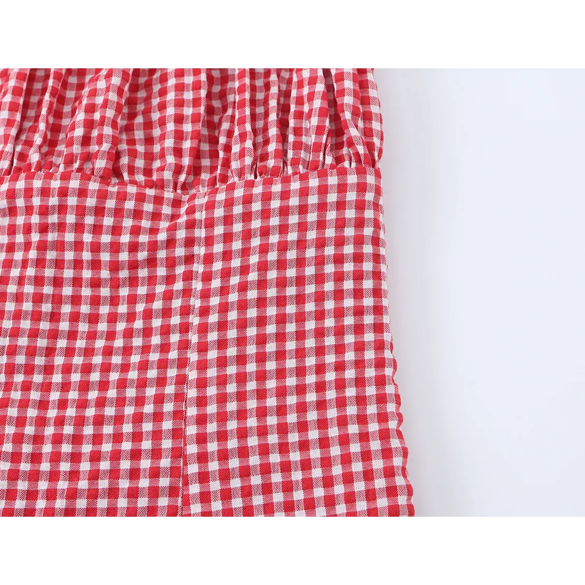 Close-up of the transition between the fitted bodice and the peplum hem.