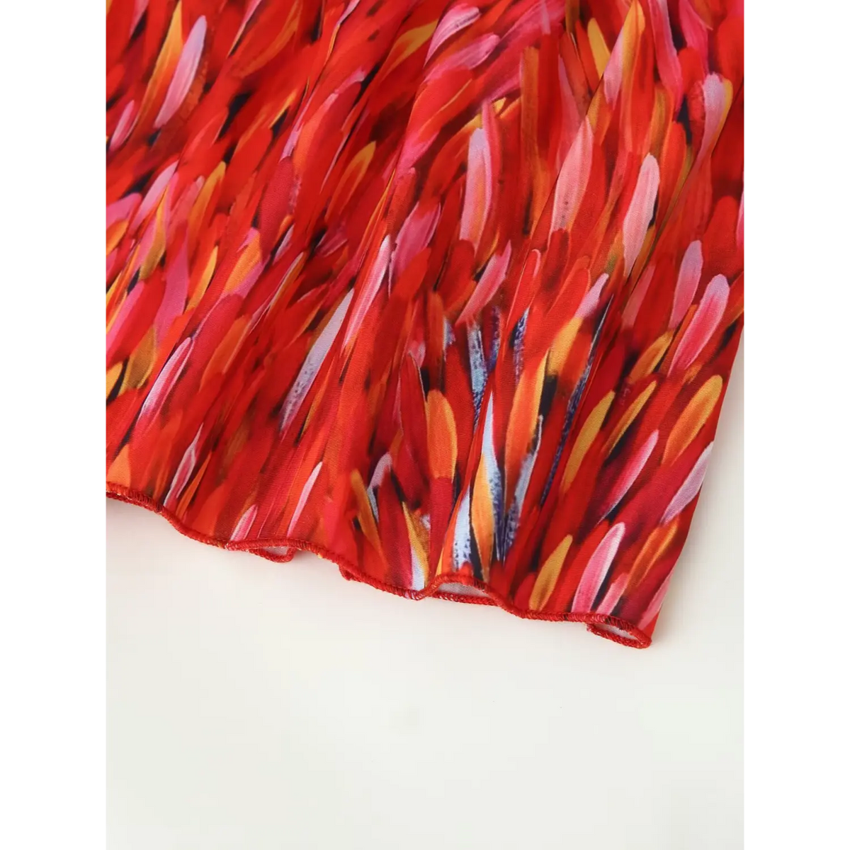 Close‑up finished skirt hem edge red abstract print halter tiered maxi dress