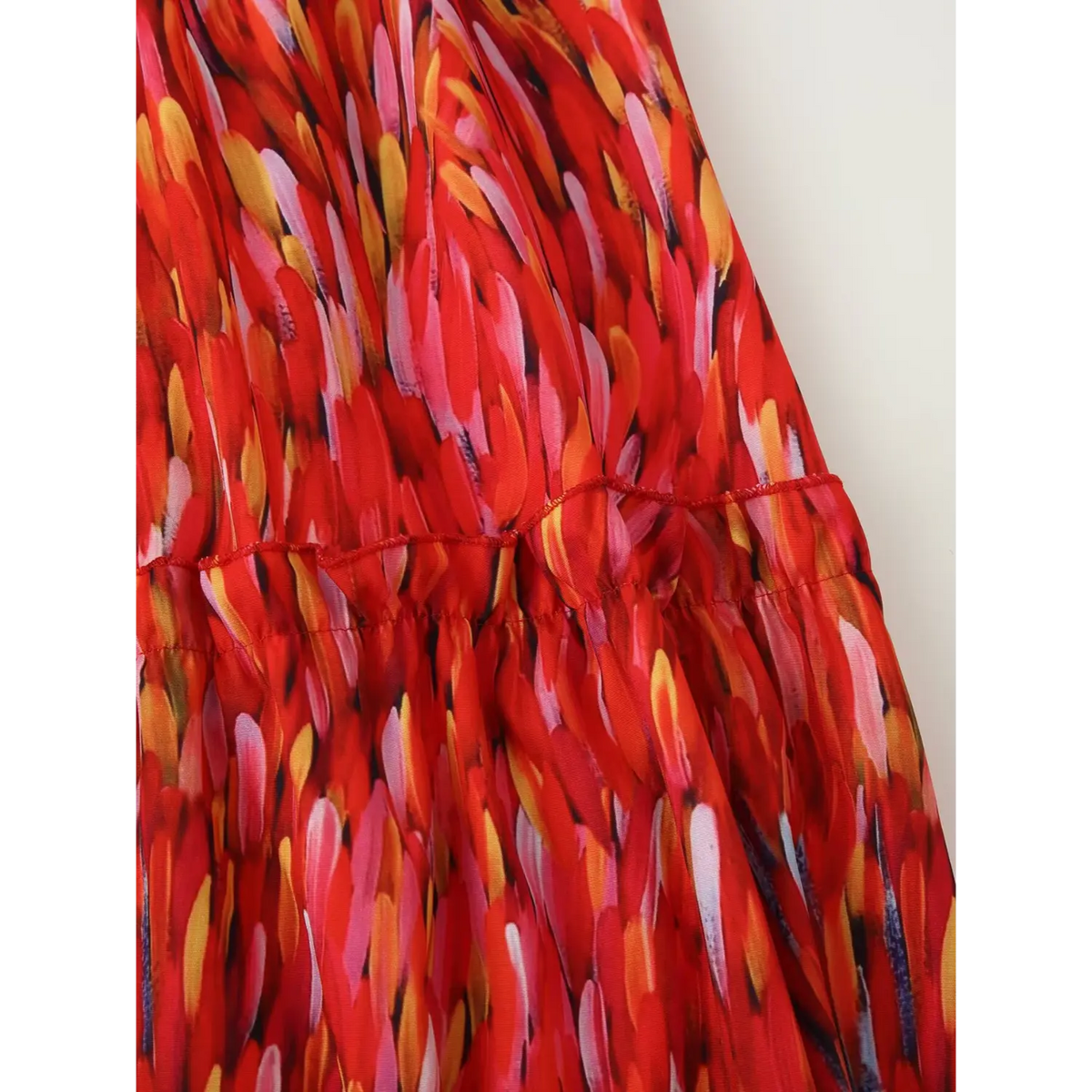 Extreme close‑up tiered ruffle seam finish red flowy halter maxi dress