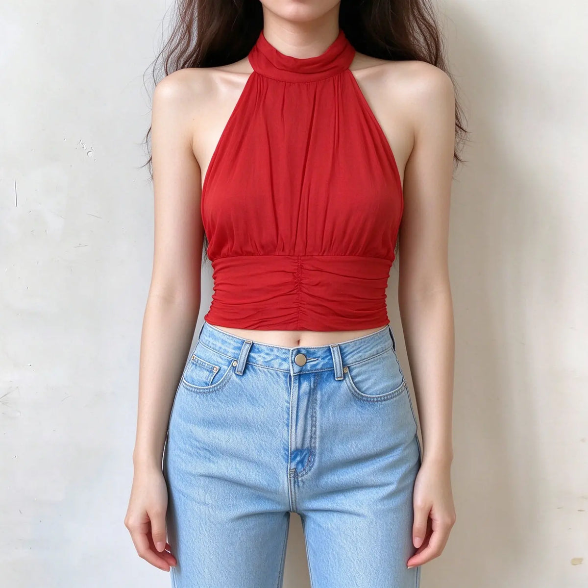 Model wearing red halter neck crop top, sleeveless backless design, front ruched detail, lightweight fabric, fitted cropped silhouette