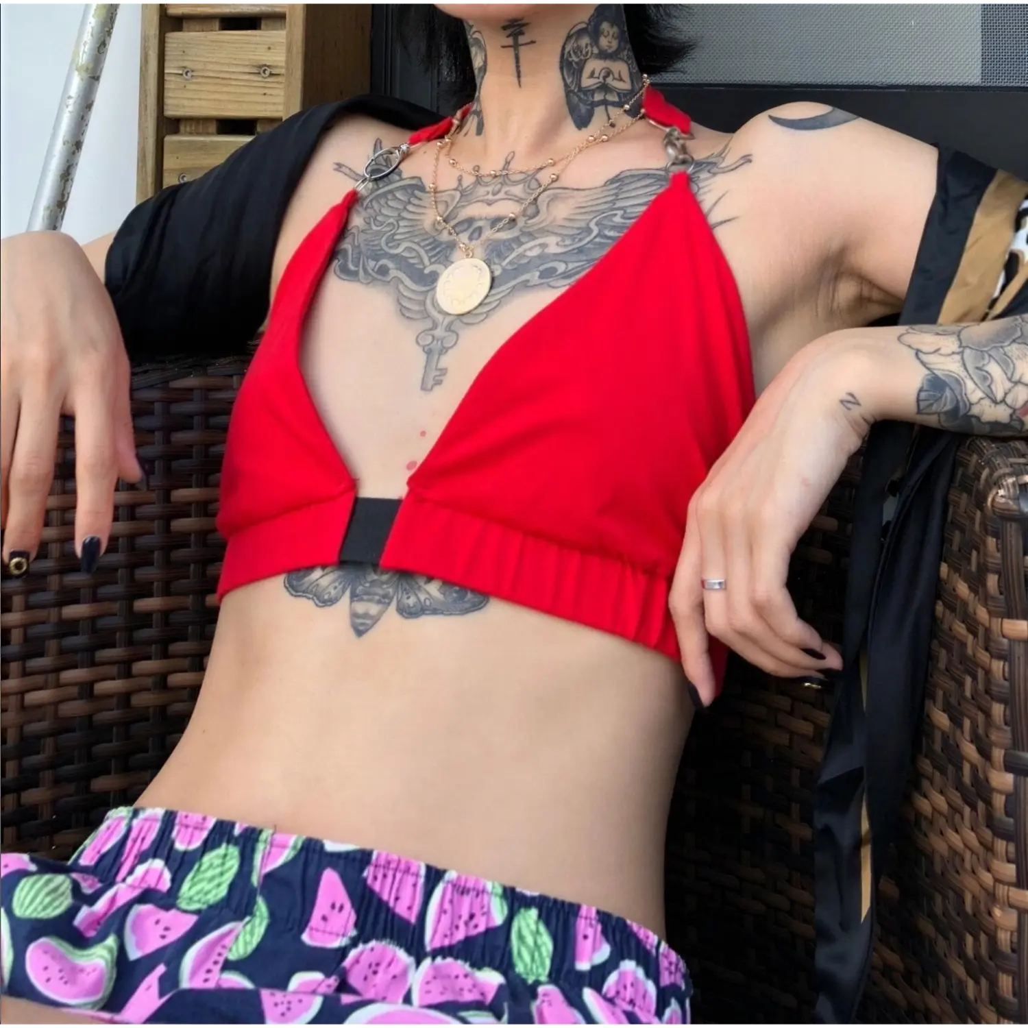 Model worn shot red deep v halter neck triangle crop top, cropped fit outdoor lifestyle view