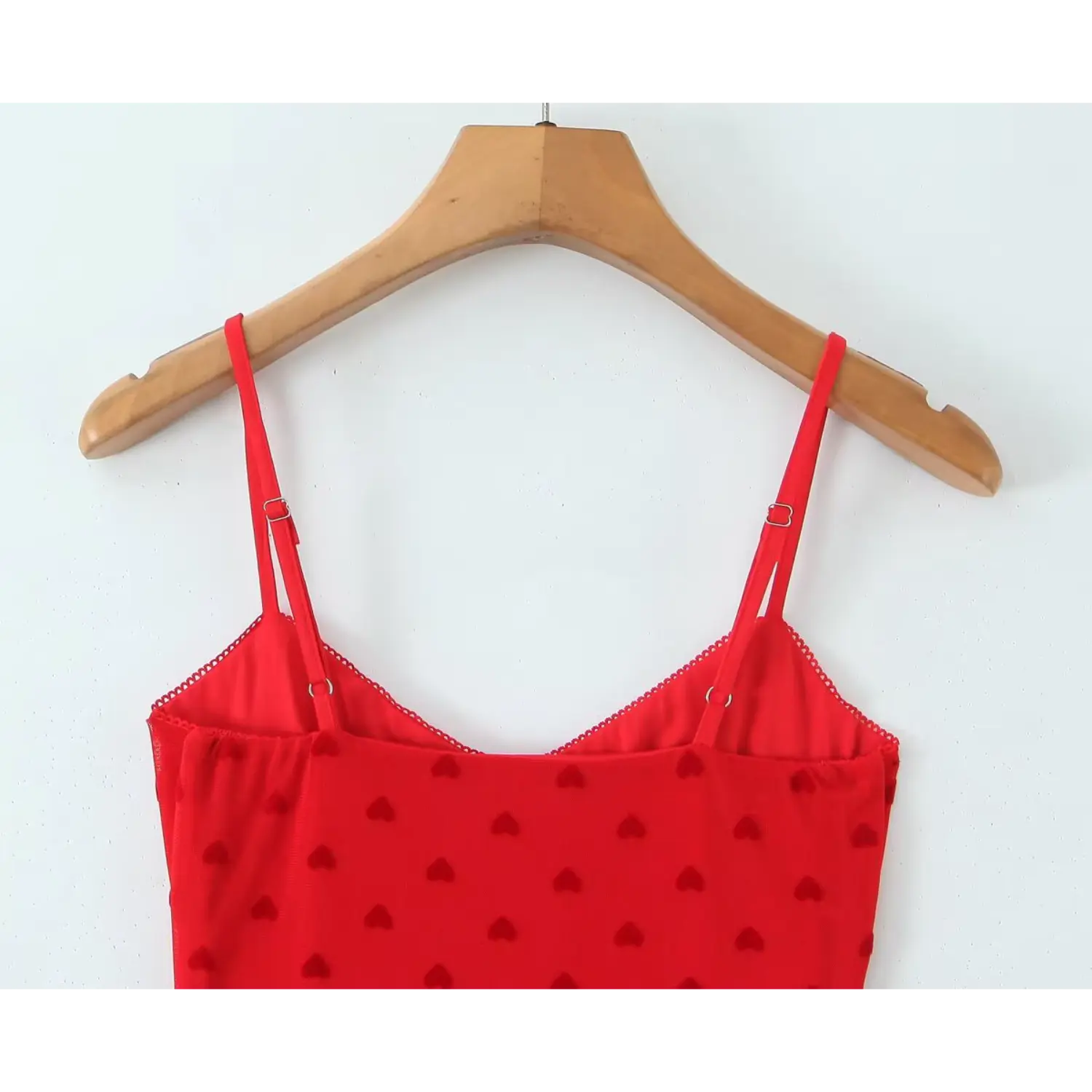 Close‑up back adjustable metal buckle spaghetti straps and back neckline red flocked heart mesh cami dress