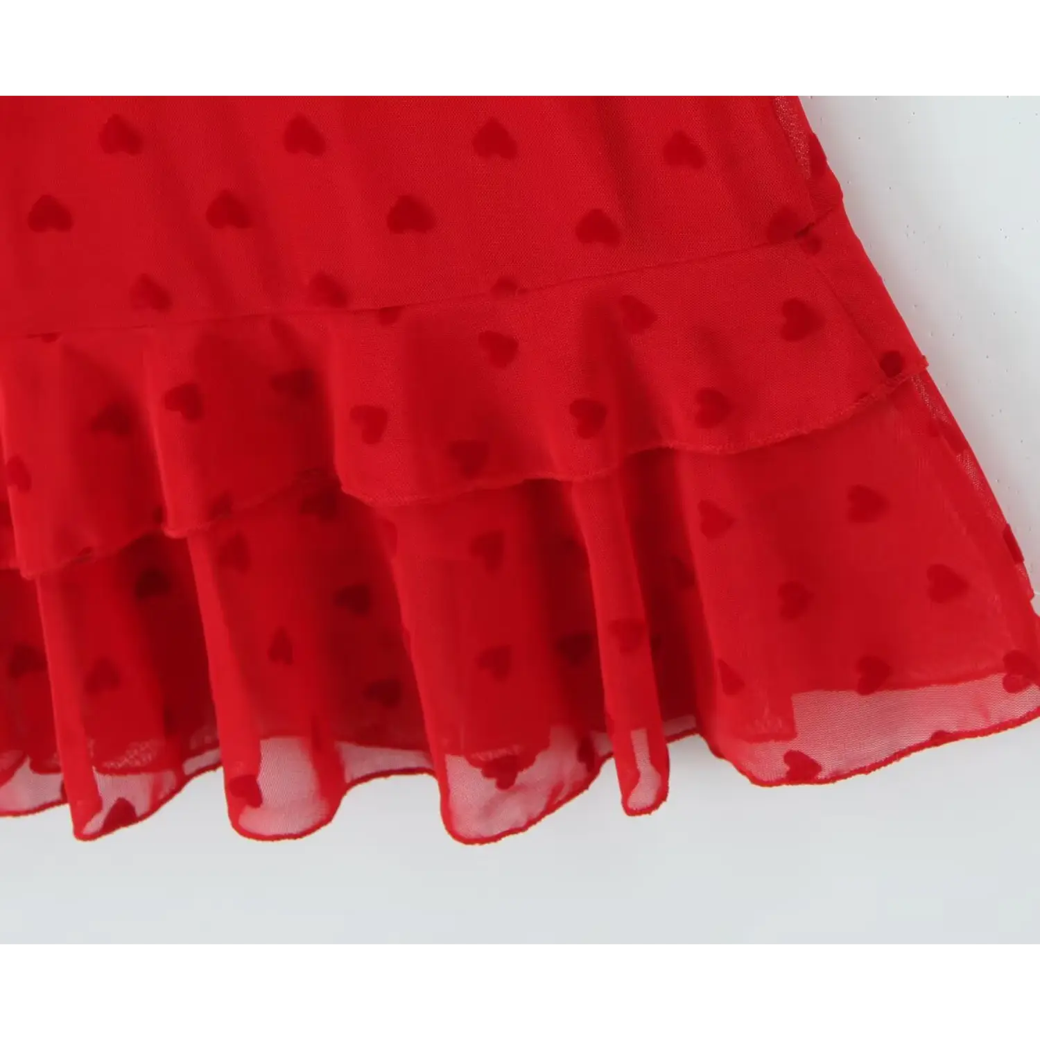 Close‑up layered ruffle hem detail red heart print mesh cami dress sheer mesh edge