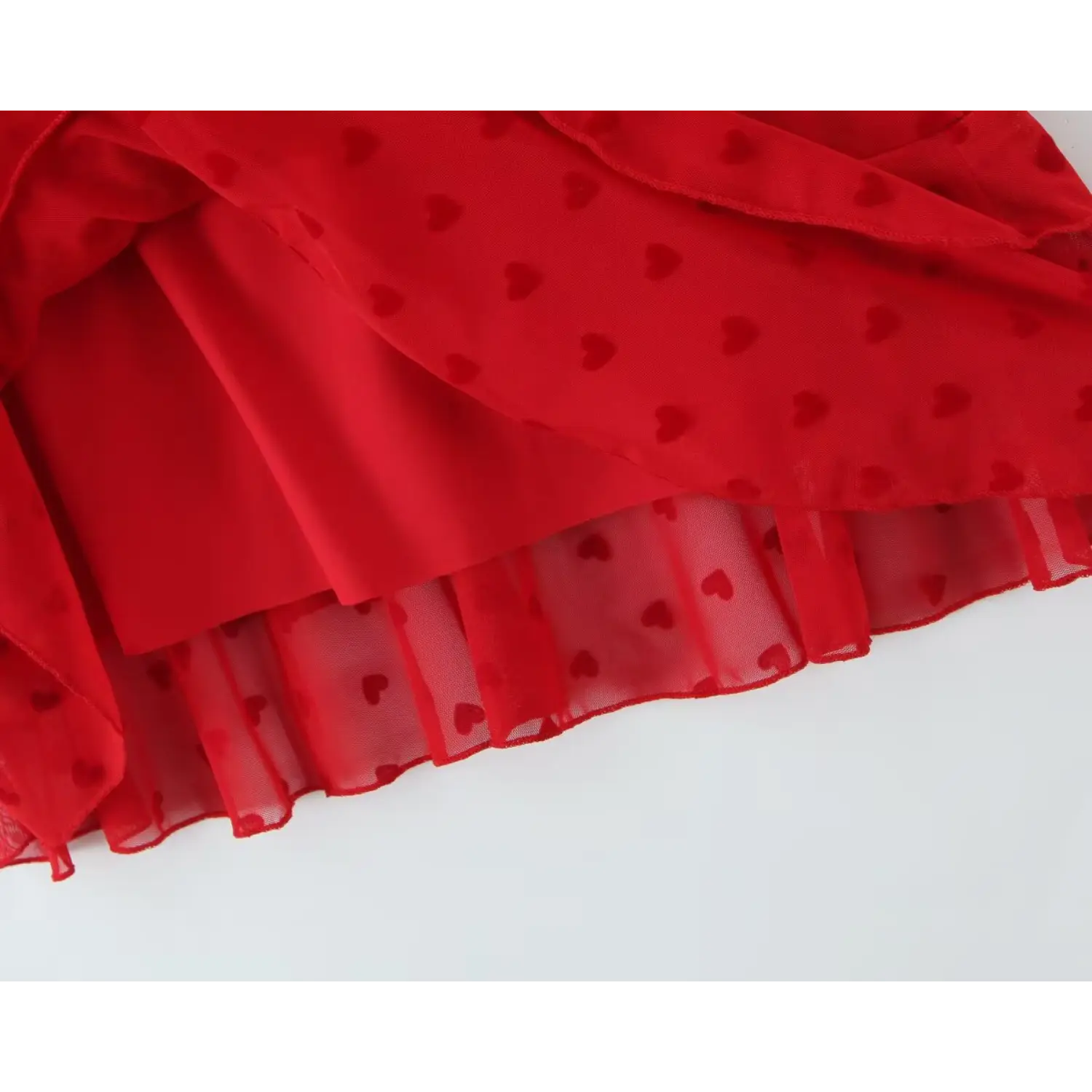 Close‑up inner lining and sheer mesh hem construction red heart print cami dress