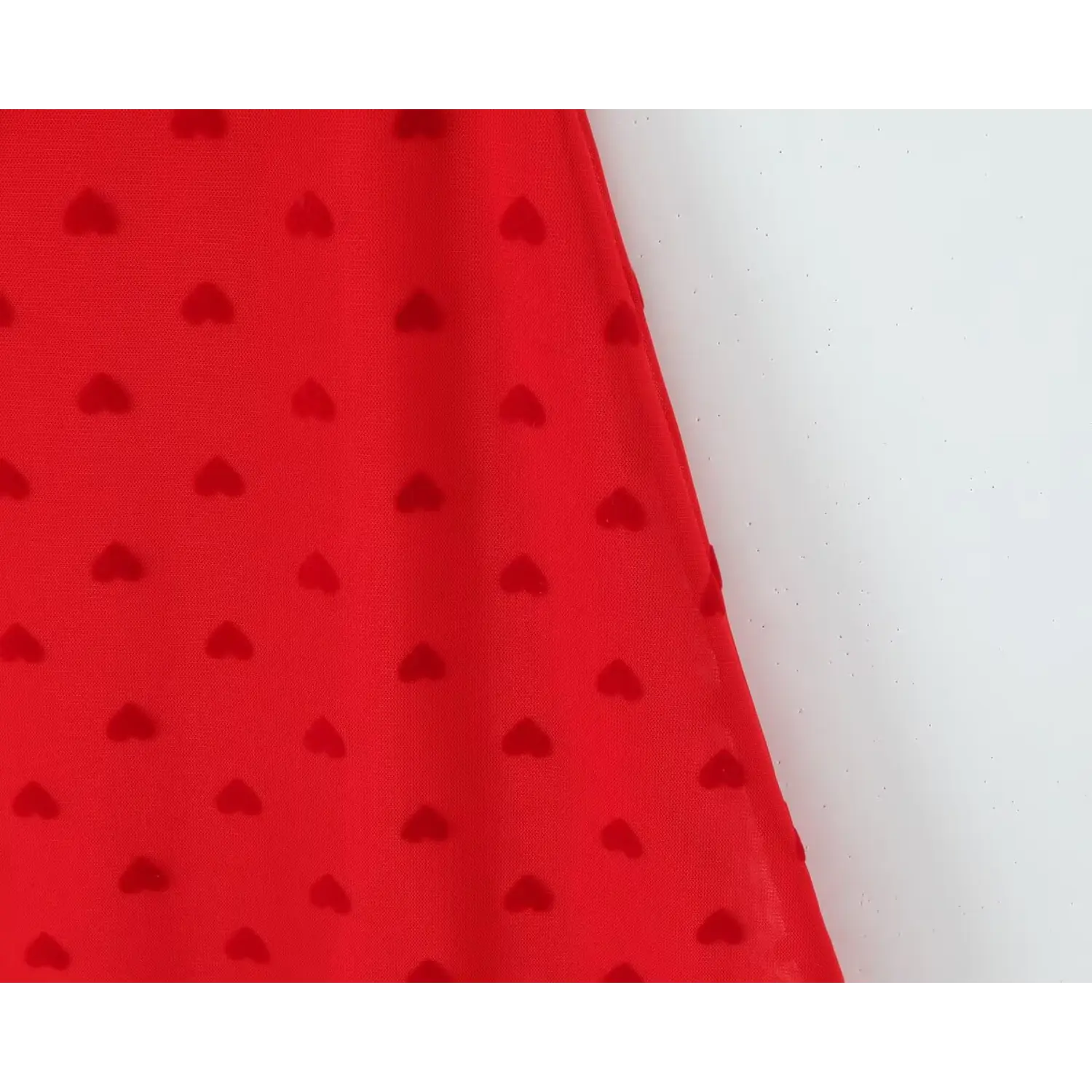 Side view close‑up red stretch mesh fabric with all‑over flocked heart print cami dress