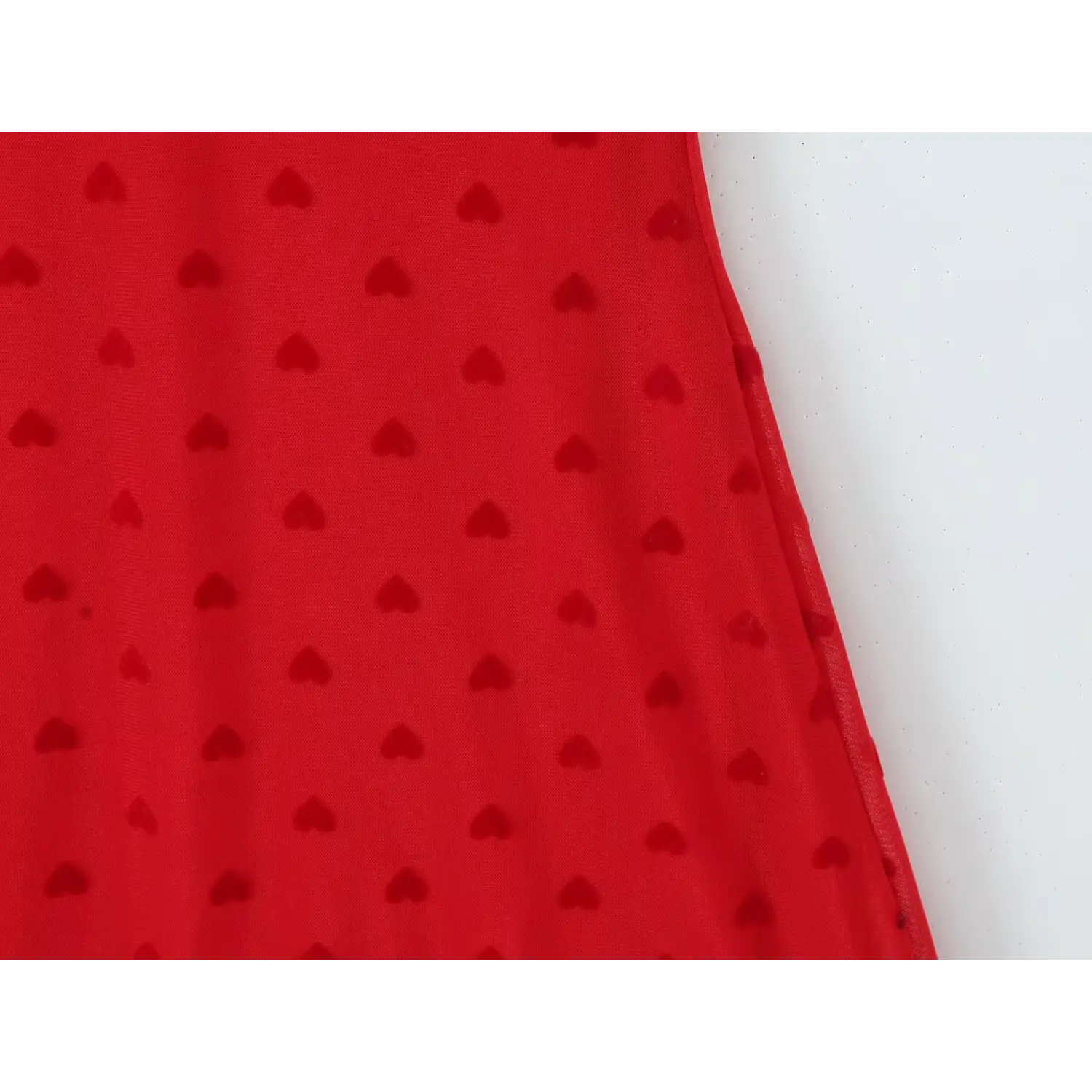 Close‑up side seam and flocked heart print fabric texture red mesh cami mini dress