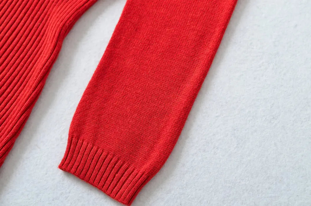 Close-up of 3/4 sleeve and ribbed cuff on red knit midi dress