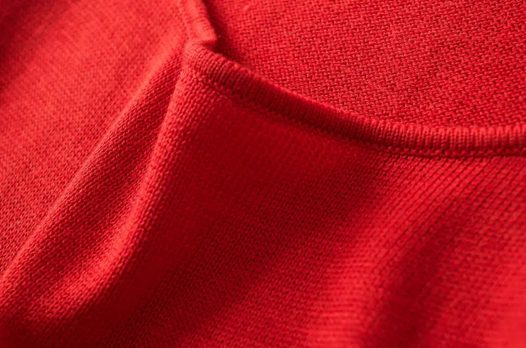 Close up texture shot of soft red knit fabric on square neck midi dress