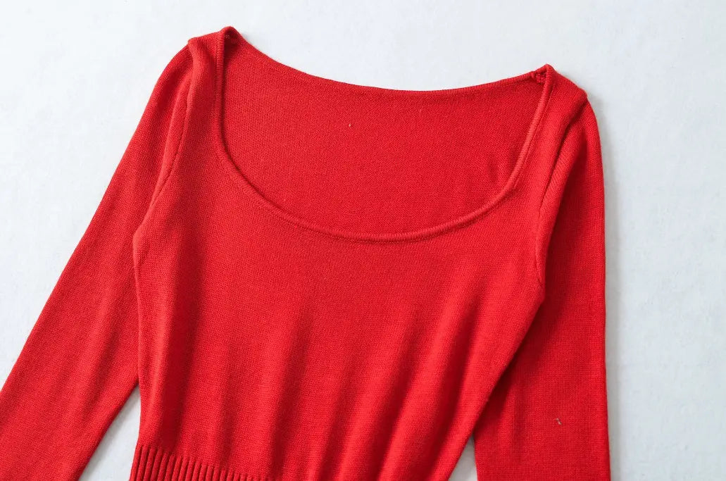 Close-up view of red knit midi dress, showing square scoop neckline and soft knit fabric