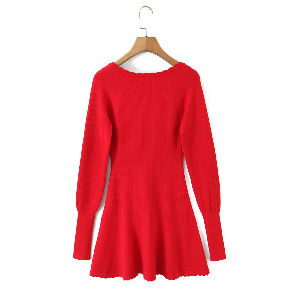 Back view of the red knit mini dress on a wooden hanger, showing the silhouette and knit texture.