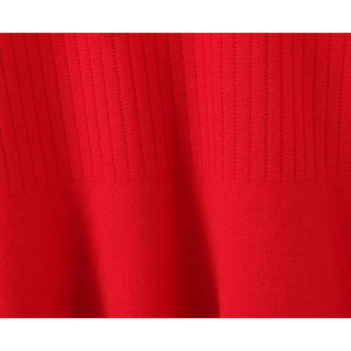  Close-up of the ribbed knit fabric texture on the red dress.