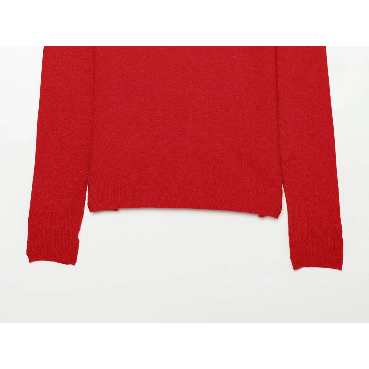 Partial shot of bottom hem and long sleeves of red color block knit polo top
