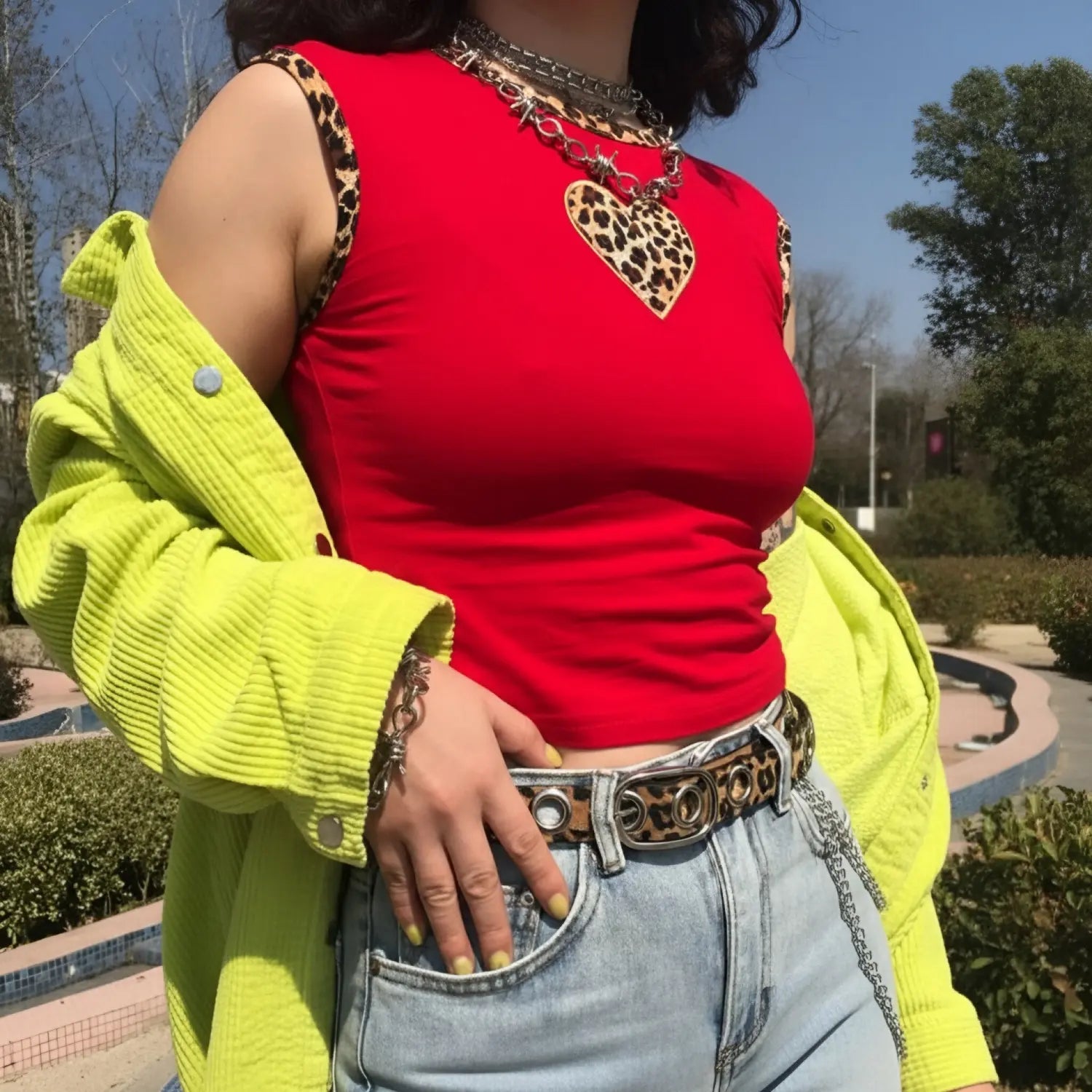 Outdoor model photo, fitted red sleeveless crop top with leopard heart decoration