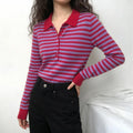 Model wearing red and lilac striped polo knit top with black high-waisted trousers