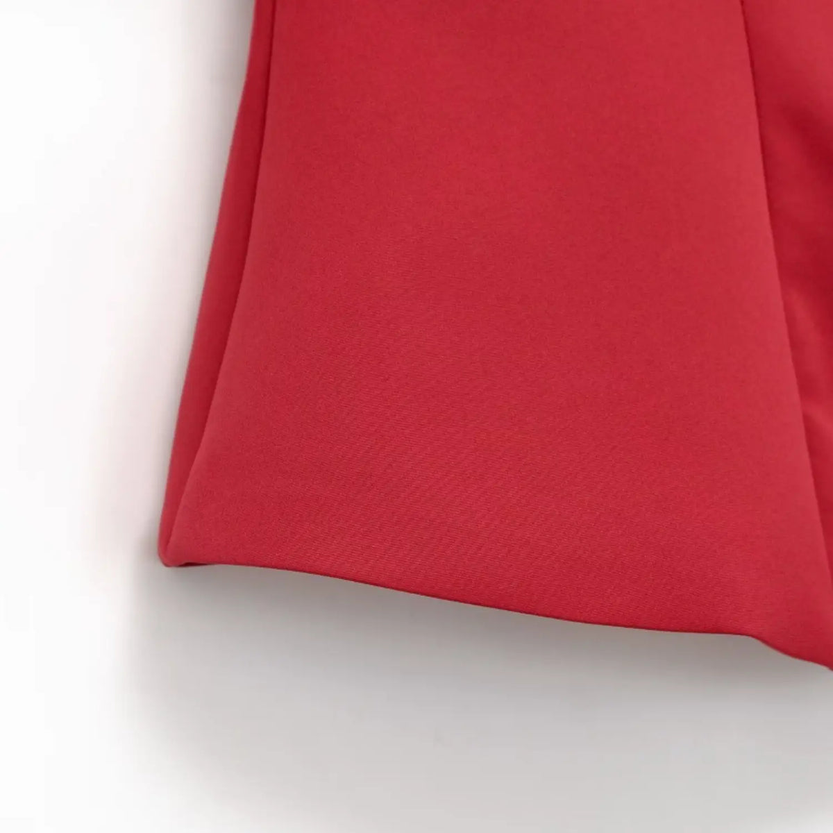 Close-up shot of red new chinese top hem, smooth solid fabric and tailored peplum cutting