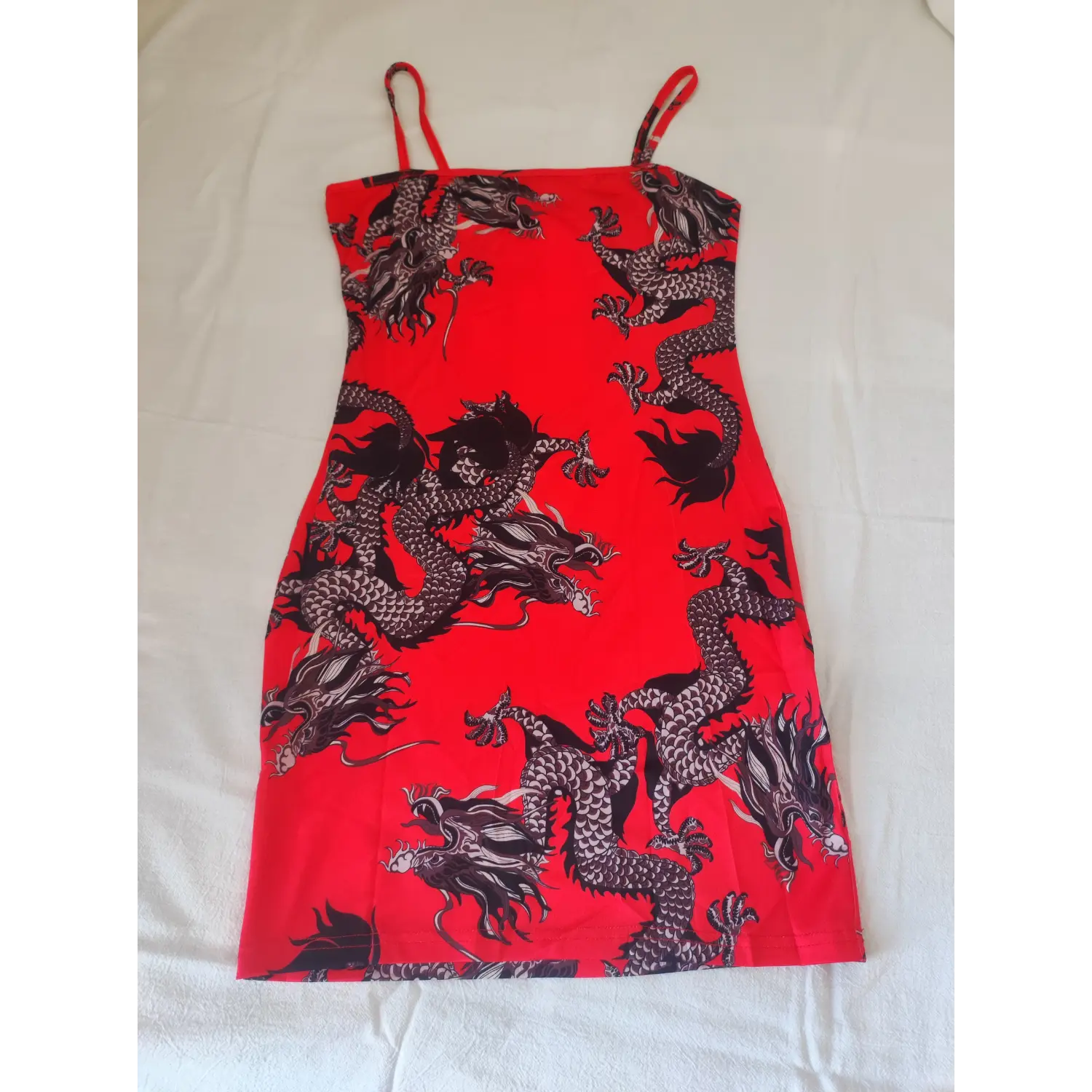 Full flat lay front shot, vibrant red dragon print slim fit spaghetti strap mini dress