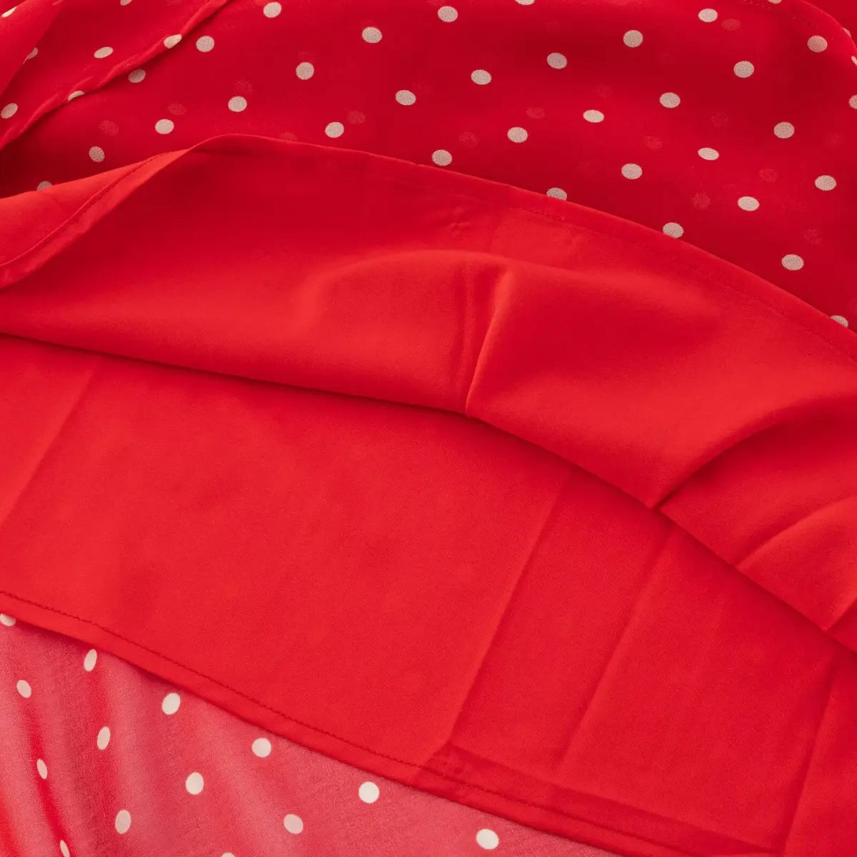 Full back hanger shot of red polka dot chiffon halter dress, halter tie closure and fitted waist silhouette.