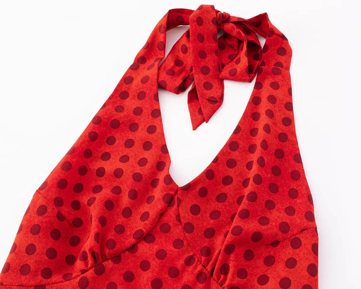 Close-up of the halter neckline and tie closure on the red polka dot dress