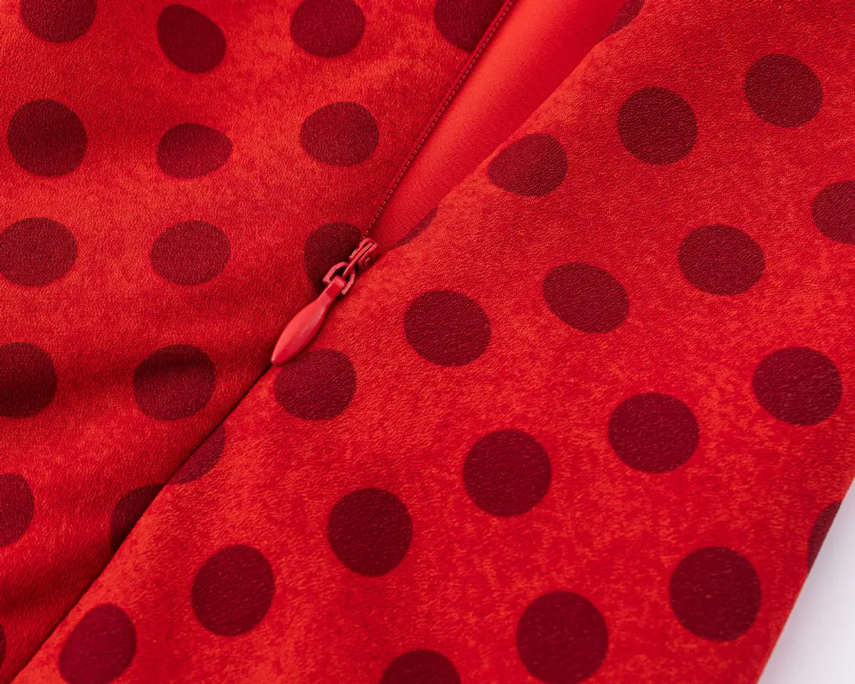 Close-up of the side zipper closure on the red polka dot halter dress