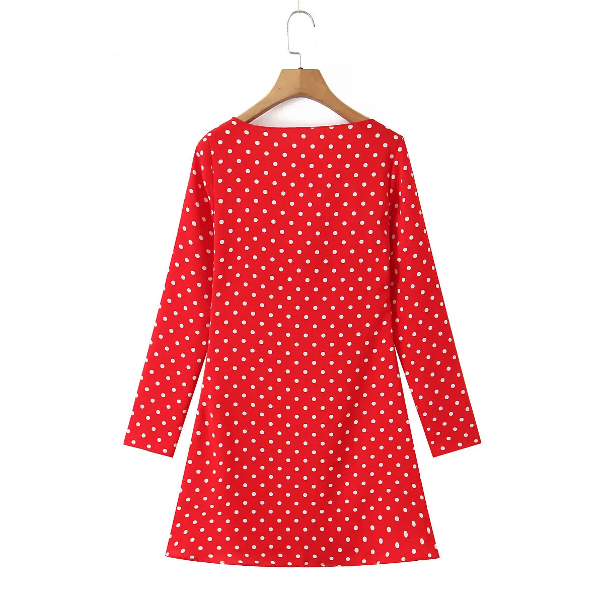 Back view of the red polka dot mini dress on a wooden hanger, showing silhouette and print.