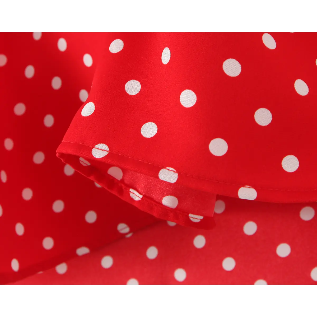  Close-up of the fabric texture, polka dot print, and inner lining on the red dress.